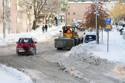 A snowy road with a snow plow in Sweden