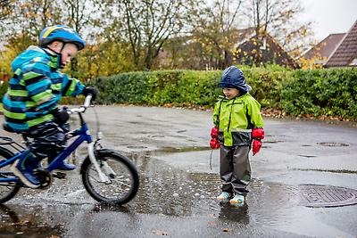 Children playing in autumn rain.